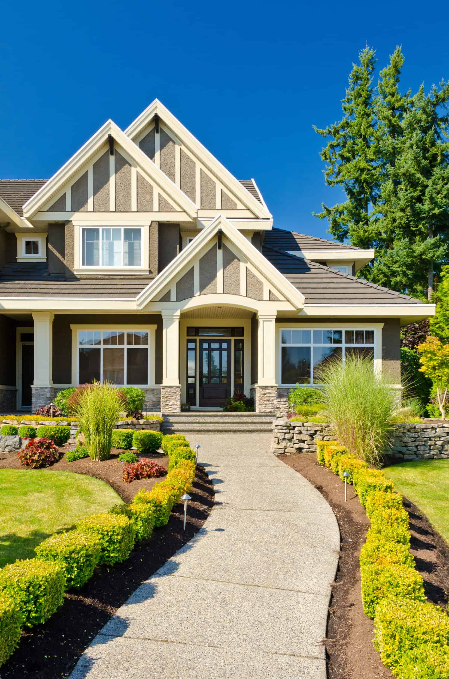 Cream and Stone Exterior Residential Home Cream and stone exterior residential home with white trim, dark roof, and dark front door in Stockton, California