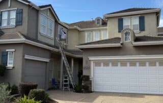 Exterior Painting: Painters on a ladder painting a home