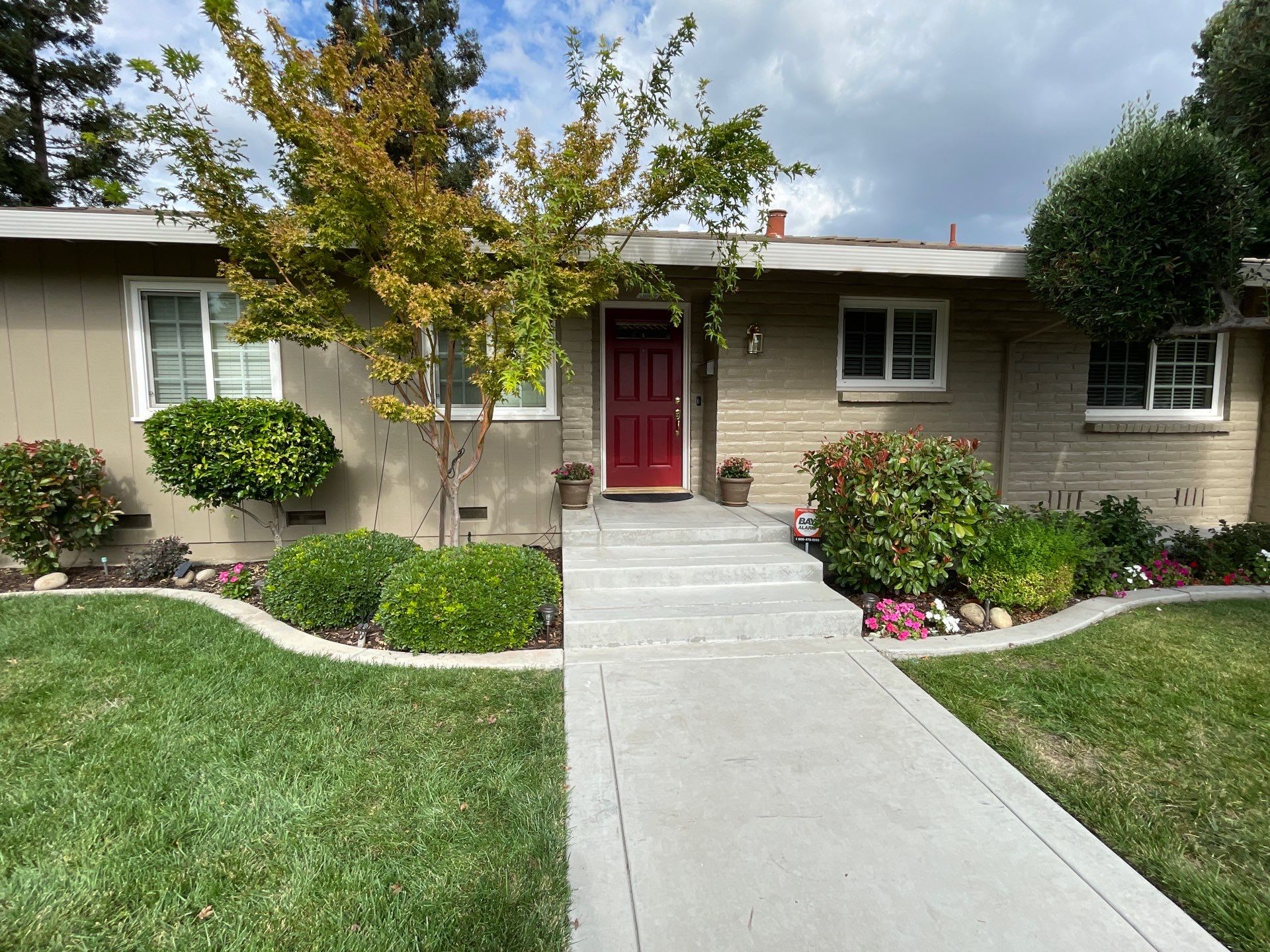 6120 Cumberland Nicely painted house siding, brick wall, and front door.