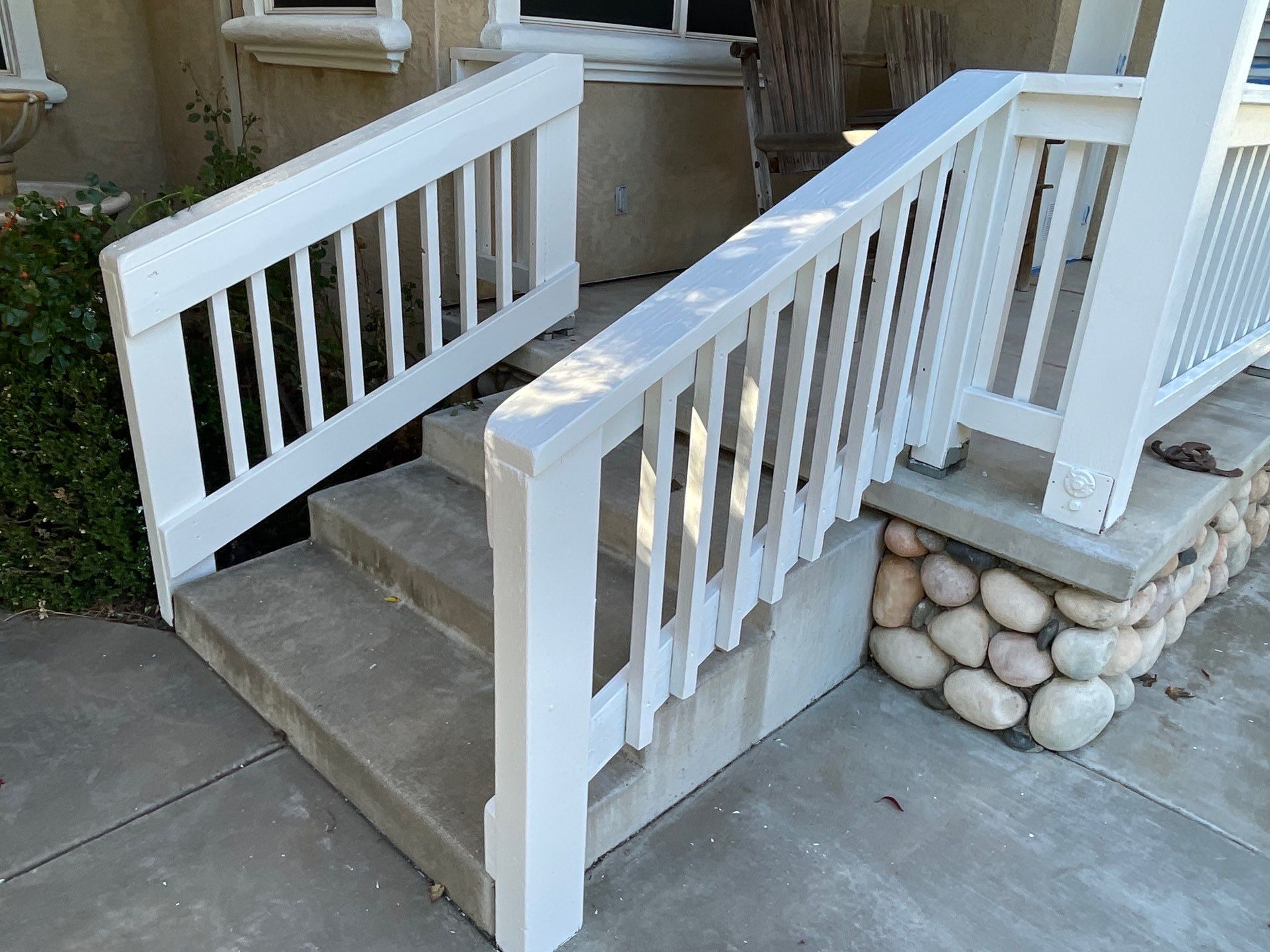 Amerigo Exterior painting project refreshing patio railing and fencing.