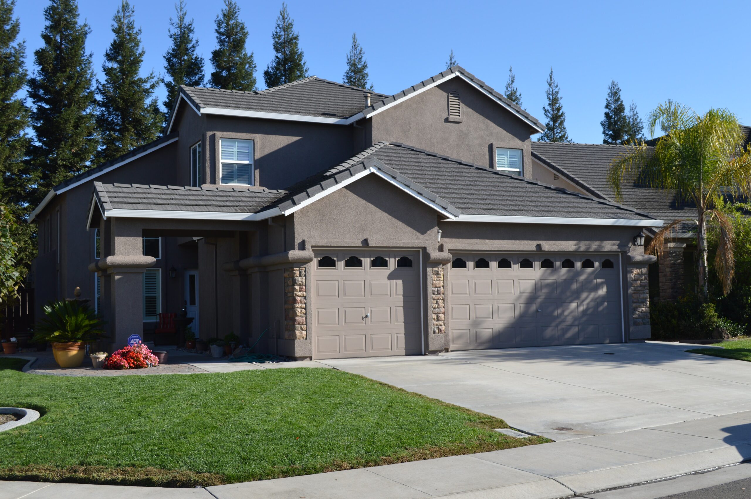 House exterior painting Suburban home with expertly painted stucco exterior.