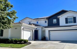 White house exterior with dark gray accent facade. best exterior paint colors